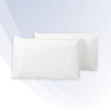 "Two white textured pillows on a light gray background"