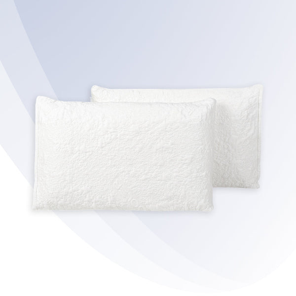 "Two white textured pillows on a light gray background"